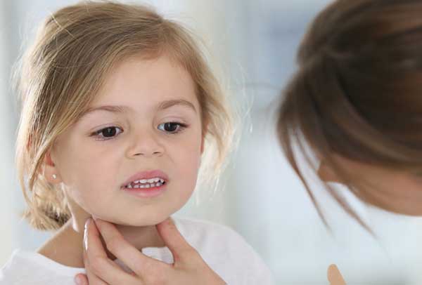 nurse performing exam on pediatric